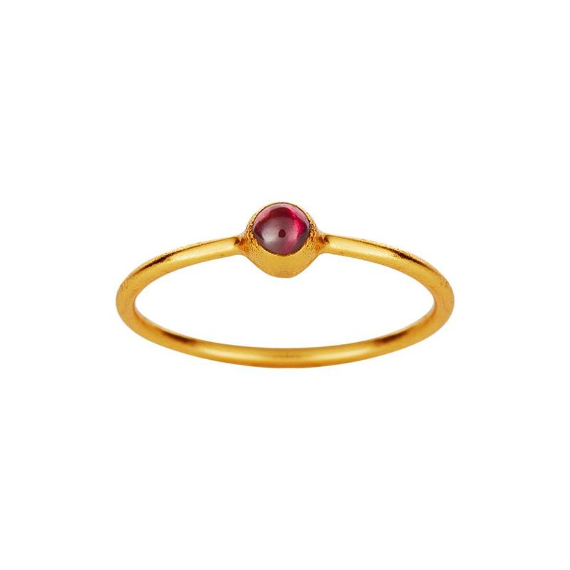 Gold plated ring with small red garnet